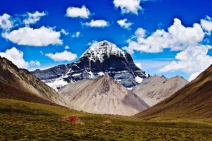 The Kailash Mansarovar Yatra is a highly revered pilgrimage, particularly for Hindu, Buddhist, and Jain devotees. It offers a unique opportunity to visit the extraordinary form of Lord Shiva, represented by a distinct black granite structure that includes the sacred Shivalingam. Mount Kailash, the holiest mountain on Earth, is revered and worshipped by pilgrims, yogis, and devotees from around the globe. Undertaking the Kailash Mansarovar Yatra is considered the ultimate "Tirth Yatra," enlightening the ignorant and expanding the mind to perceive new meanings in life. This journey to the abode of Lord Shiva, Nirvana, is both a once-in-a-lifetime adventure and a profoundly sacred experience. The Significance of Mount Kailash Mount Kailash holds immense significance as the holiest mountain, revered by four major religions. In Hinduism, it is believed to be the divine throne of Lord Shiva. In Buddhism, the mountain is associated with the highest tantric meditation deity, Demchong, symbolizing supreme bliss. Even before the advent of Buddhism in Tibet, the indigenous Bon religion considered Mount Kailash sacred. According to Bon mythology, the founder of Bon, Shenrab, descended from heaven at Mount Kailash. Hence, followers of the Bon religion view the entire region around Kailash as mystical, considering the mountain to be a nine-story swastika, the seat of all spiritual power. For all these religions, Mount Kailash is the origin of four rivers—the Indus, Brahmaputra, Sutlej, and Karnali—which symbolize the life-giving forces dividing the world into four regions.